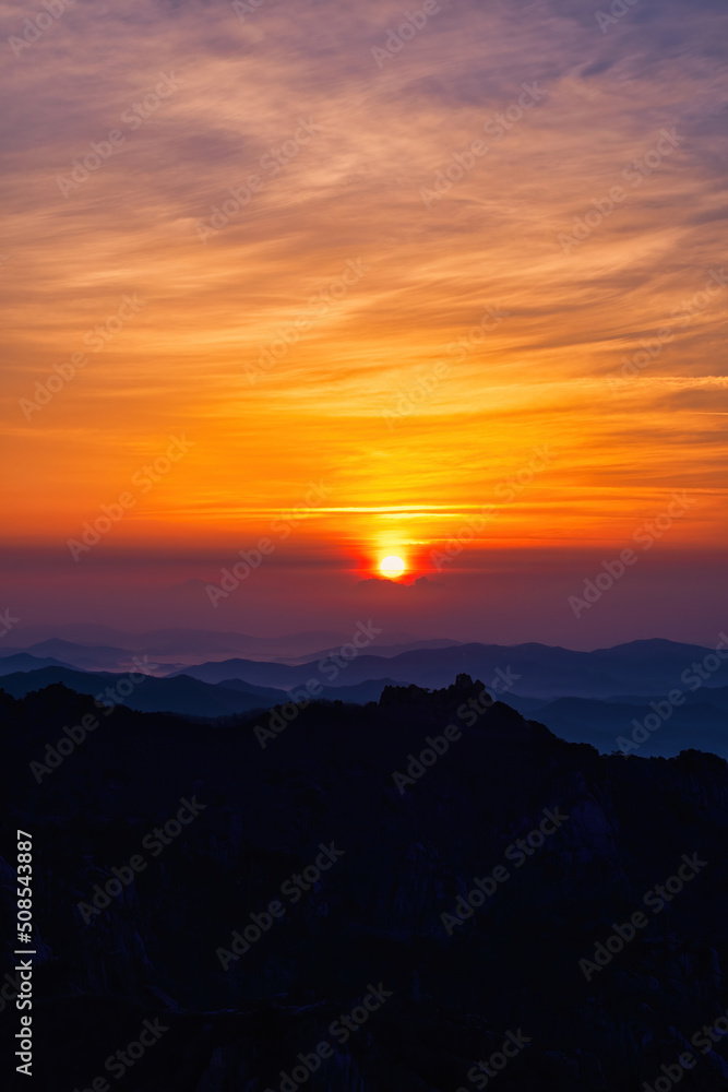 Scenic view of mountains against sky during sunrise Scenic view of mountains against sky during sunrise