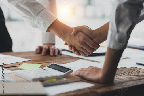 Business partnership meeting concept. Image business woman handshake. Successful business people handshaking after good deal. Group support concept. photo