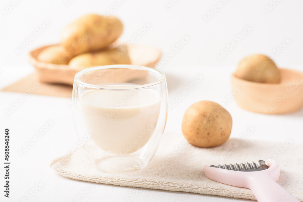 Potato milk in a glass, a healthy plant based drink on white background Potato milk in a glass, a healthy plant based drink on white background