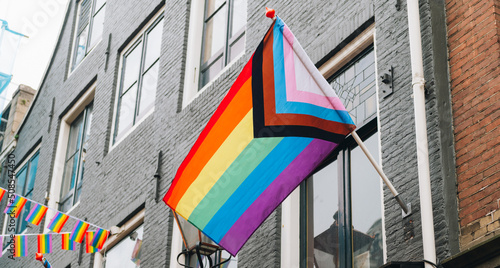 Modern progress 2022 LGBTQ pride flag during pride month. Includes people of color. Rainbow gay, transgender and queer symbol for equality. Celebration of pride month © Anastasiia