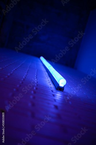 Blue Neon Light on Brick Wall