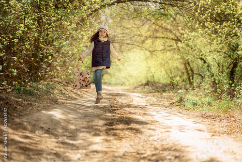 Little pretty girl on walk in sunny spring park. Fairy forest. High quality photo