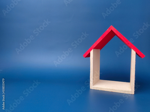 Toy house on blue background with copy space