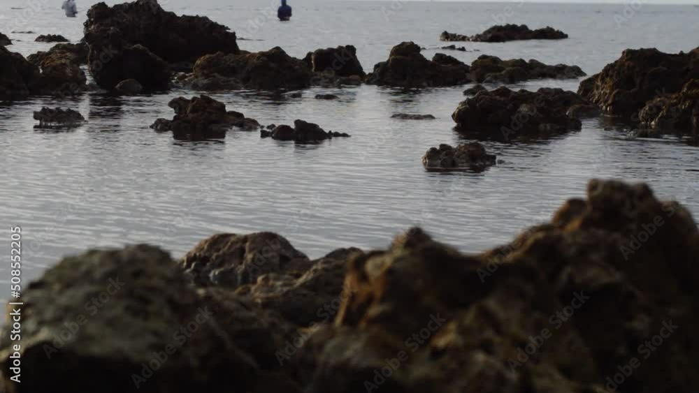 Natural Calm Ripples Of Tropical Sea Water Between Chunks Of Rock On The Beach In The Dusk Light Natural Calm Ripples Of Tropical Sea Water Between Chunks Of Rock On The Beach In The Dusk Light