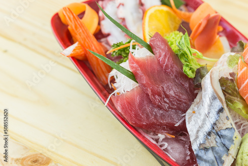 boat sashimi laid on wooden floor photo