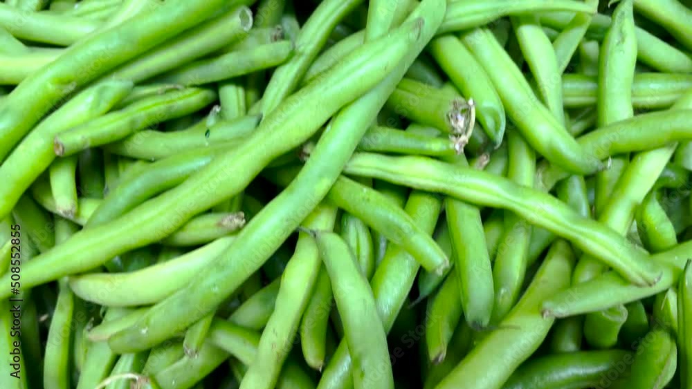 Retail store produce pile of raw green beans Retail store produce pile of raw green beans