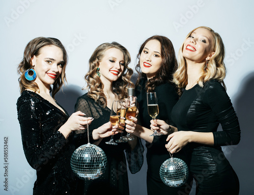 Four Party women in black dress with disco balls