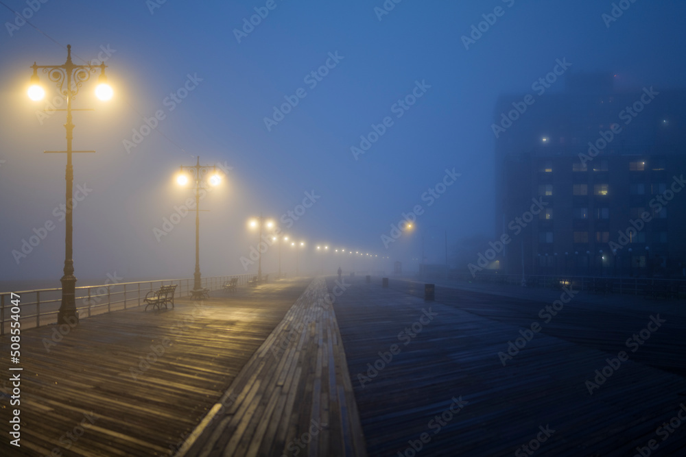 Street lights, foggy misty night, lamp post lanterns, deserted road in mist fog. High-quality photo