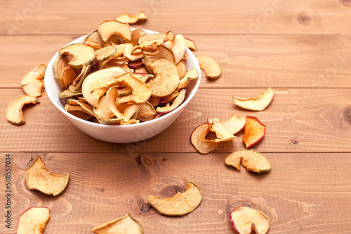 close-up of dried apples in slices on a wooden table. food products. proper nutrition. source of vitamins
