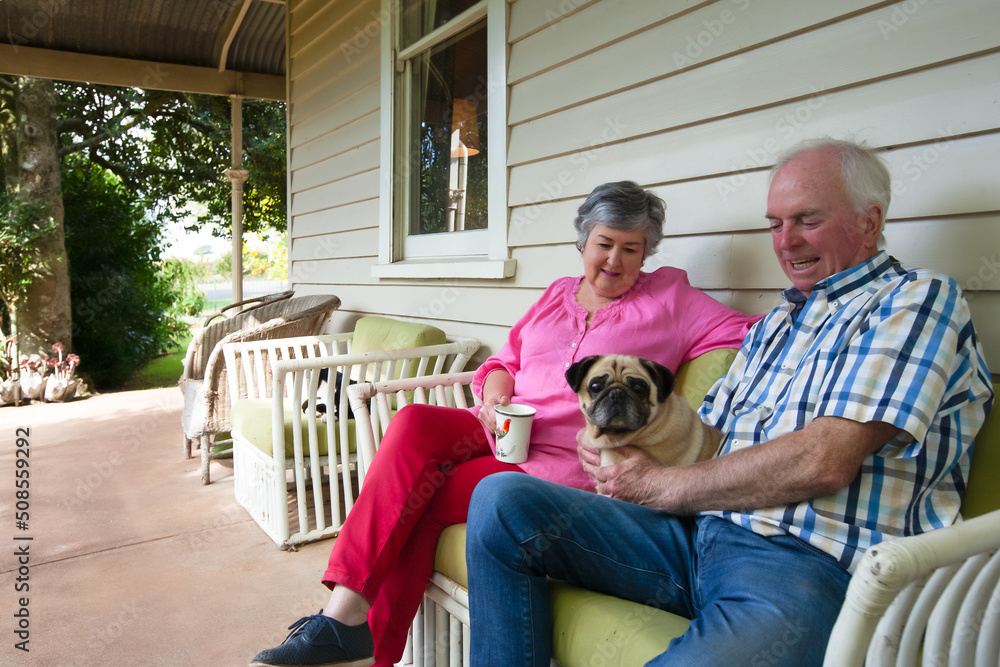 Old couple sitting on the front porch with their pet dog Stock Photo ...