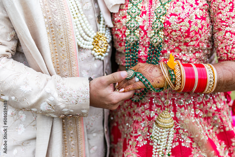Indian married couple's holding hands close up