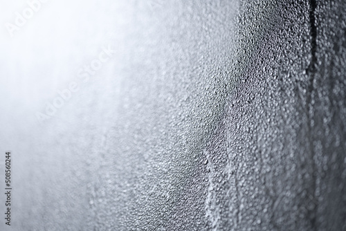 Foto Drops of water on a black surface, glass, close-up