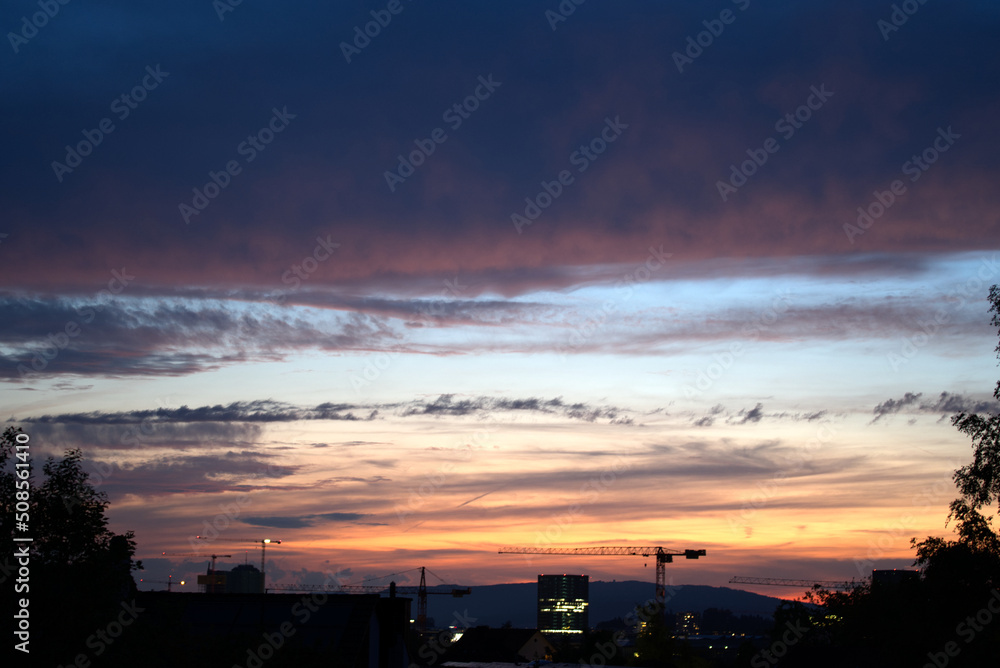 Dramatic night sky with office tower at City of Zürich with industrial skyline on a cloudy spring day. Photo taken May 2nd, 2022, Zurich, Switzerland. Dramatic night sky with office tower at City of Zürich with industrial skyline on a cloudy spring day. Photo taken May 2nd, 2022, Zurich, Switzerland.