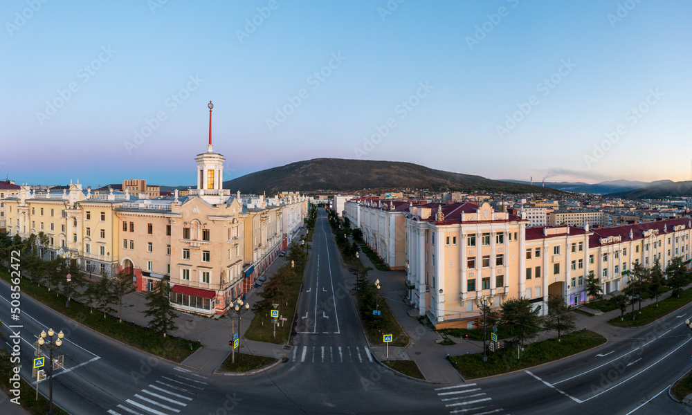 Aerial view of the city of Magadan. Streets and buildings in the historical center of the city. Beautiful old tower with a spire. View of Portovaya street. Magadan, Magadan region, Russian Far East.