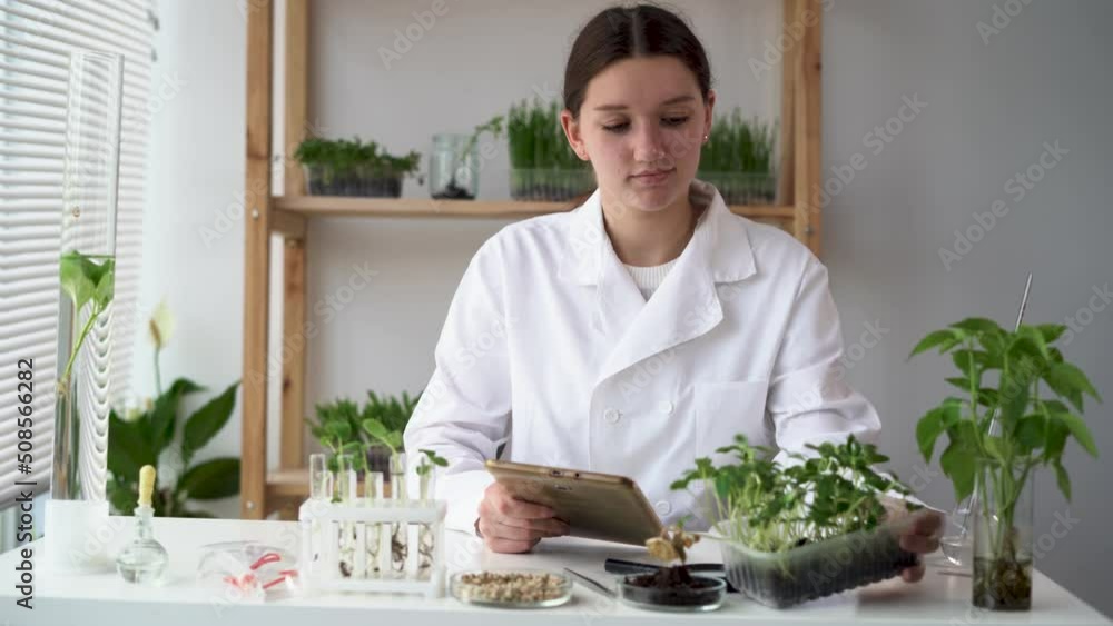 Young woman microbiologist is using digital tablet computer. Medical scientist working on plant-based meat substitute for vegetarians in a food science laboratory. Young woman microbiologist is using digital tablet computer. Medical scientist working on plant-based meat substitute for vegetarians in a food science laboratory.