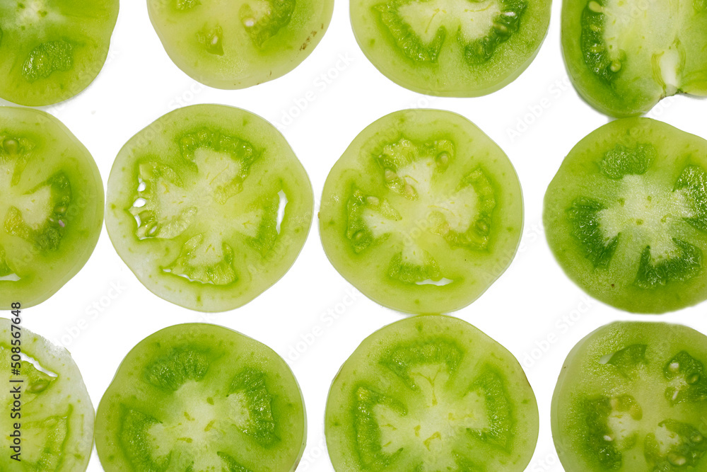 Green tomato pieces isolated on white background. Green tomato pieces isolated on white background.