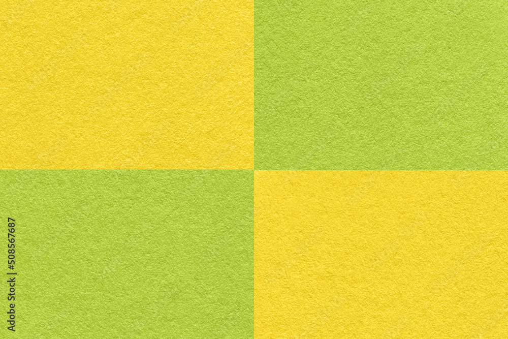 Texture of craft green and yellow paper background with cells pattern, macro. Structure of vintage dense kraft cardboard
