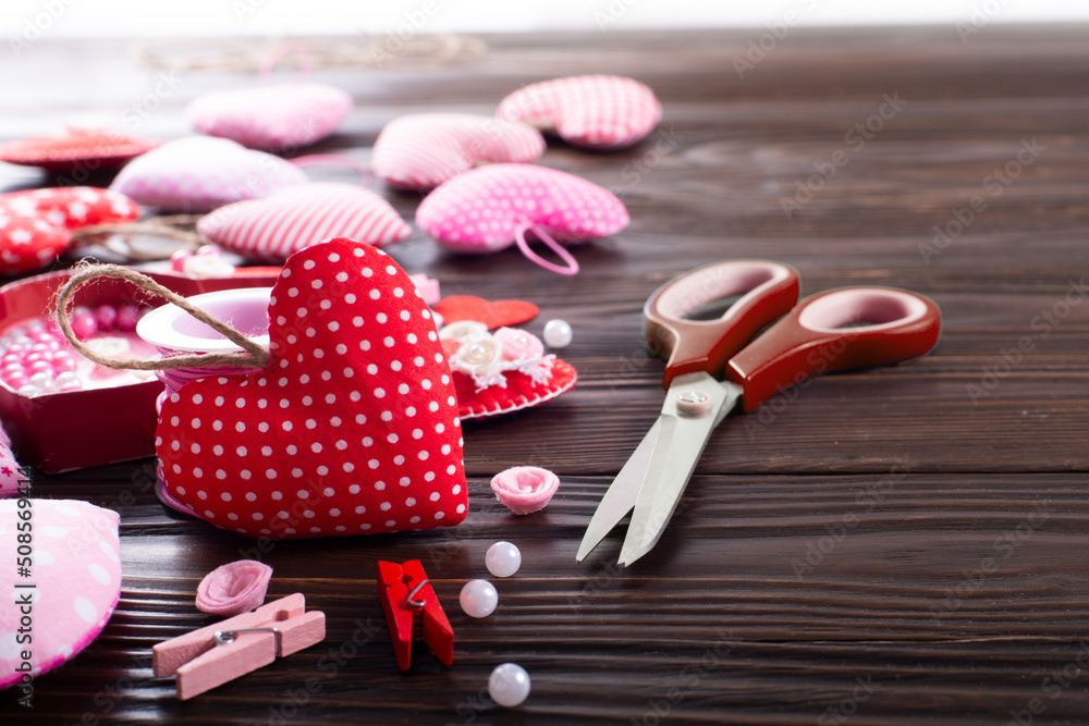 Valentines day handmade fabric decorations on wooden table low angle view