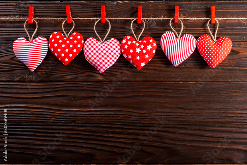 Obraz na płótnie Valentine fabric hearts hanged on rope on dark wooden background w salonie