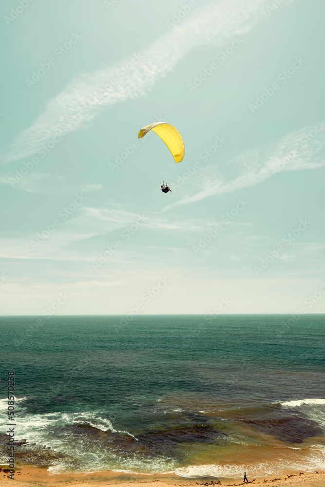 Yellow parachute on the coast with a horizon Yellow parachute on the coast with a horizon