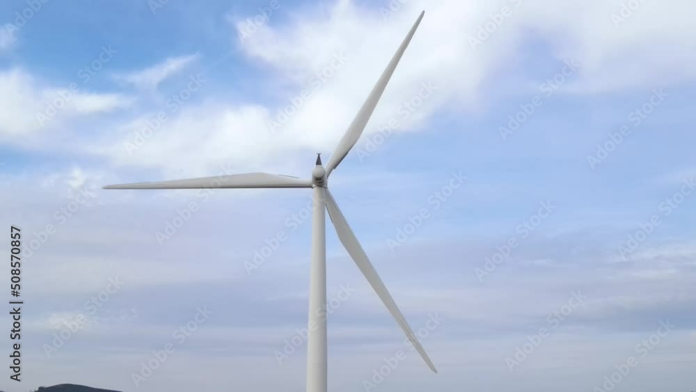Aerial shot of a row of wind turbines along the ridge of a mountain Aerial shot of a row of wind turbines along the ridge of a mountain