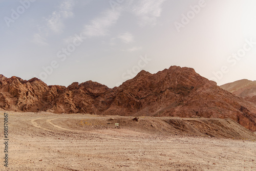 A road next to a mountainous desert landscape. Road 12 on the way to Eilat, Israel, on the Egyptian border. Mountains in different and varied sand colors. High quality photo