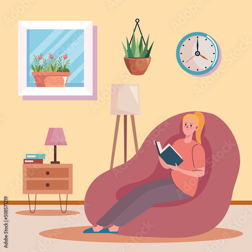 woman reading book in livingroom