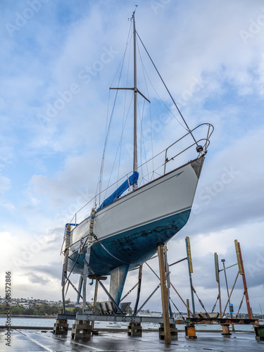 Small yacht on dry dock stand being repaired photo