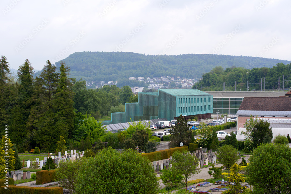 Fototapeta premium Cemetery at City of Brugg, Canton Aargau, with beautiful flowers on a cloudy spring day. Photo taken May 6th, 2022, Brugg, Switzerland.