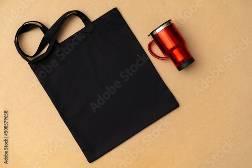 Textile shopping bag and coffee cup flat lay