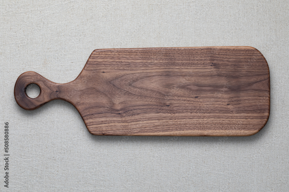 Walnut handmade wooden cutting board on burlap background. Stock Photo |  Adobe Stock
