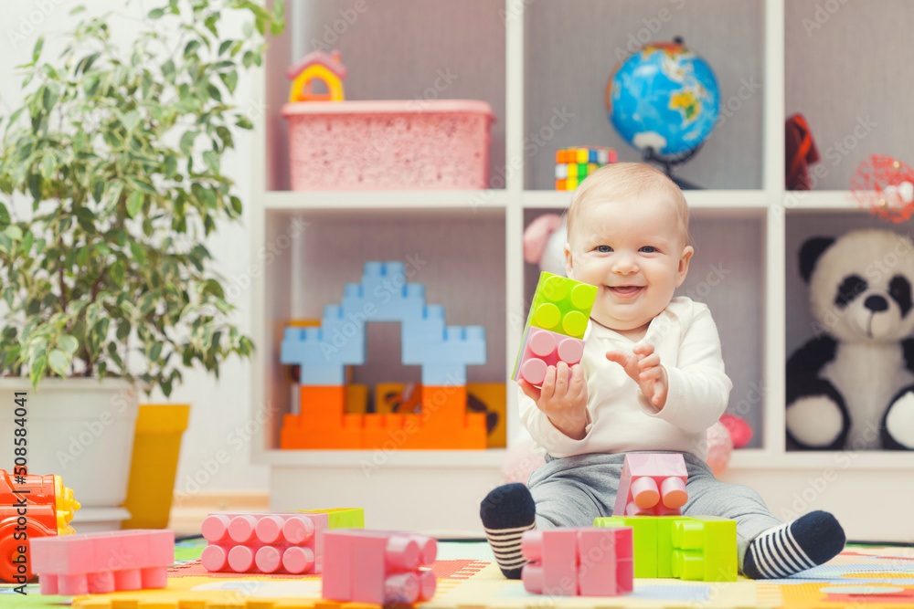 baby playing with colourful building blocks at home or kindergarten baby playing with colourful building blocks at home or kindergarten