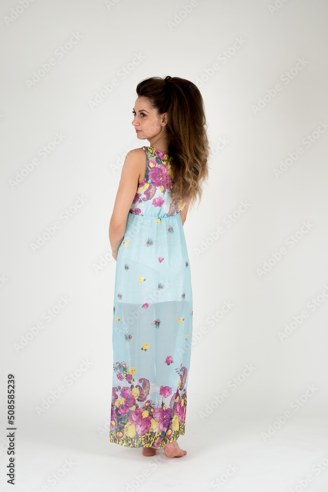a girl with long dark hair in a blue summer dress on a white background a girl with long dark hair in a blue summer dress on a white background