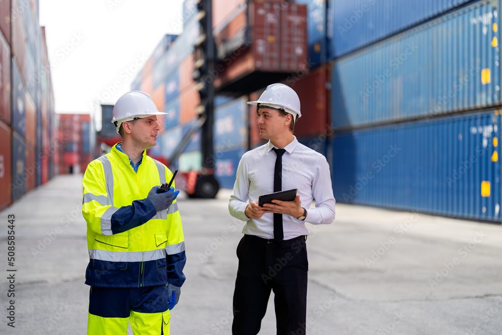 Container yard manager briefing work plan with the supervisor at container yard warehouse. Container yard manager briefing work plan with the supervisor at container yard warehouse.