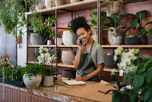 Konstfotografi Florist takes an order on the phone at flower shop