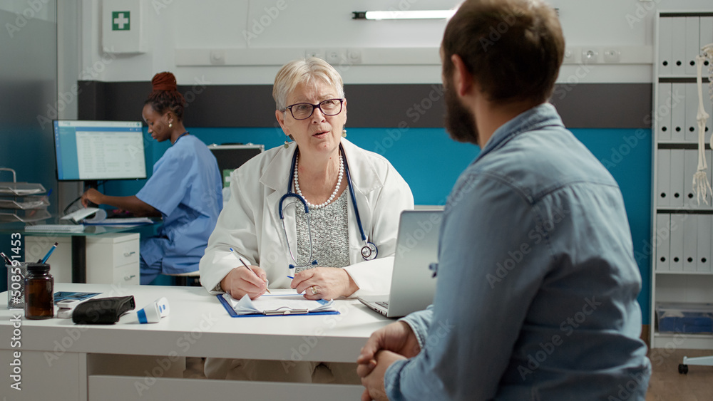 Obraz premium Physician and man having conversation about health care at appointment, doing checkup examination visit. Giving prescription medicine and treatment to patient with illness in medical office.