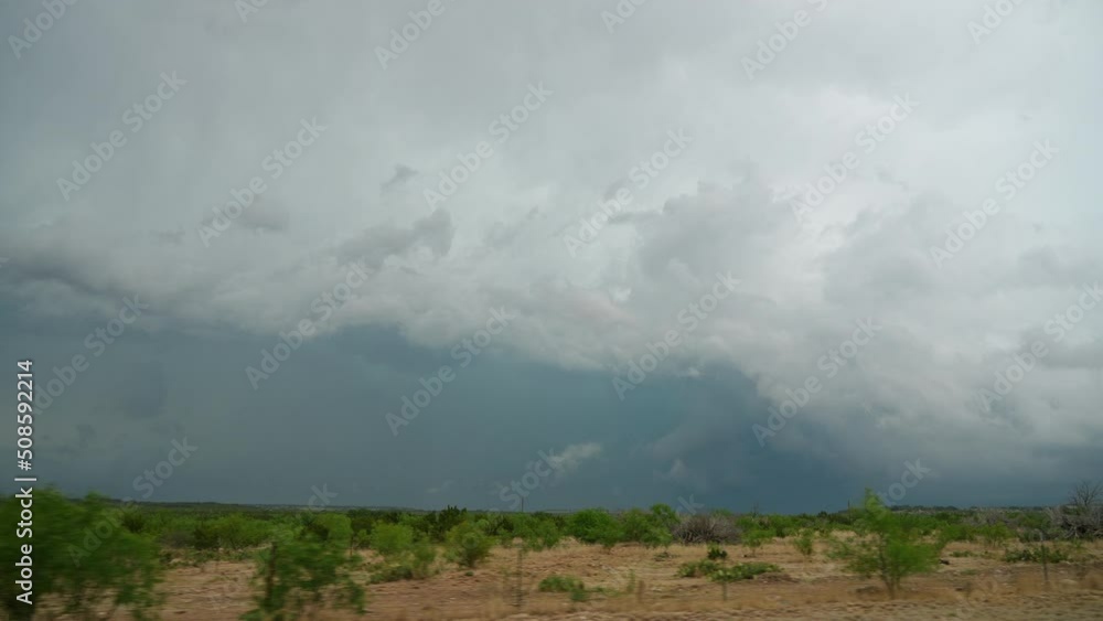 Driving through Texas looking out the window at a storm in the distance moving in slow motion. Driving through Texas looking out the window at a storm in the distance moving in slow motion.