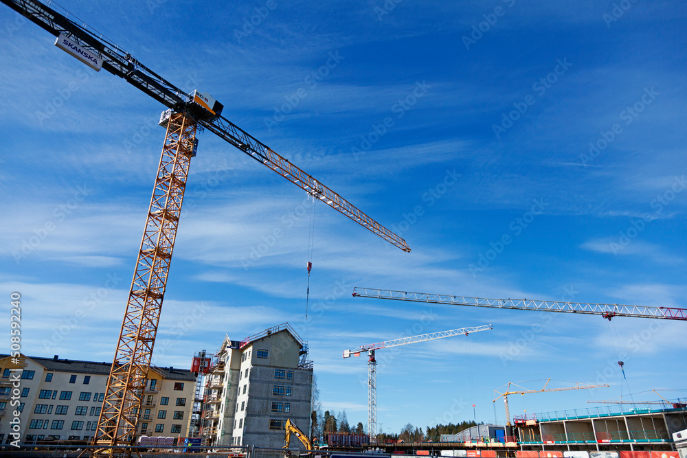 Umea, Norrland Sweden - May 13, 2022: four cranes during housing construction on Teg