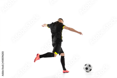 Rear view of professional male football soccer player in motion and action isolated on white studio background. Concept of sport, goals, competition, hobby, world cup © master1305