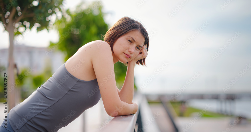 asian young strong, confident woman in sportive clothes feeling bad about to throw up. Dehydration. Chest pain. Side stitch, side cramps after running. Stomach side pain after jogging work out.