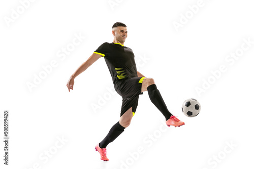 Professional male football soccer player in motion and action isolated on white studio background. Concept of sport, goals, competition, hobby, world cup