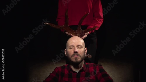 Woman cheated on her man wearing the horns of a cuckold