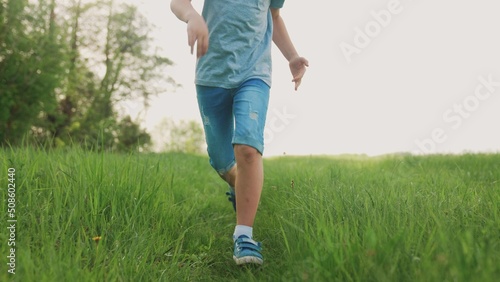 happy family. kid run legs lifestyle close-up in the park at sunset. people in the park concept boy son joyful run. happy family summer. little baby run child fun summer kid dream concept