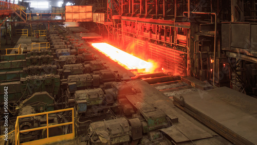 Hot red steel billet on rolling mill.