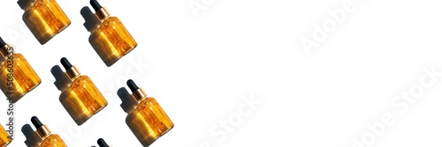 banner glass bottle with cosmetic oil or serum, with a pipette on a white background beautiful hard sunlight and a shadow from it