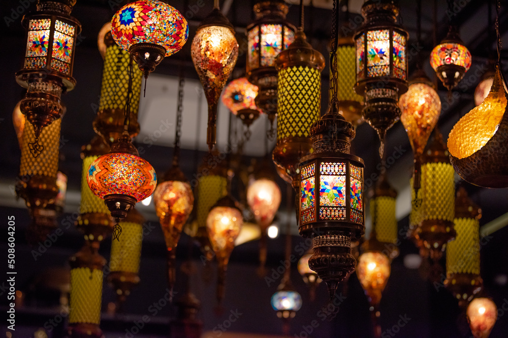 Lamps decorate the walls of buildings for illumination and beauty.