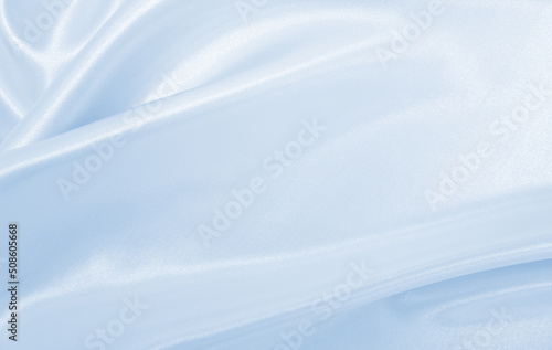Smooth elegant blue silk or satin luxury cloth texture as abstract background. Luxurious background design