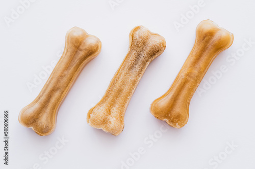 flat lay of bone shaped pet treats isolated on white.