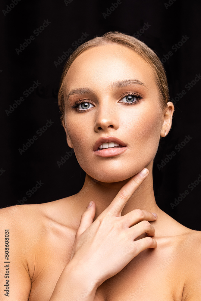 Young woman with bare shoulders and perfect fresh skin on black background Young woman with bare shoulders and perfect fresh skin on black background