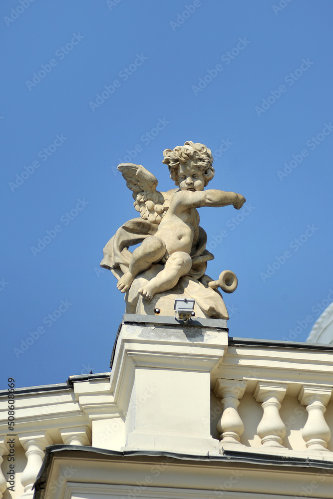 Obraz premium One of the 16 figures of the Cupid Babies on the balustrade of the Odessa Opera House in Ukraine against the sky